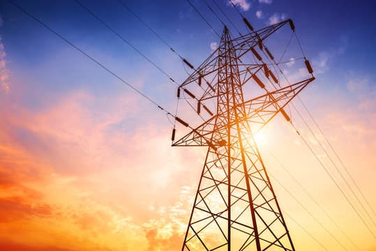 High-voltage transmission tower at dusk